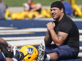 Defensive lineman Tai Pham stretches during a University of Windsor Lancer football practice. (DAN JANISSE/The Windsor Star)