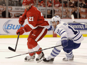 Detroit's Tomas Tatar, left, is checked by Toronto's Stephane Robidas during the second period in Detroit Saturday. (AP Photo/Duane Burleson)