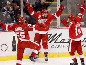 Detroit's Henrik Zetterberg, centre, celebrates with Niklas Kronwall, left, and Gustav Nyquist after his overtime goal to beat the Toronto Maple Leafs 1-0 at Joe Louis Arena Saturday. (AP Photo/Duane Burleson)