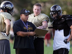 AKO assistant coach Jamie McCurdy, centre, teaches kick return drills during practice at Windsor Stadium. (NICK BRANCACCIO/The Windsor Star)