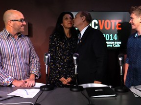 Windsor Mayoral candidate Larry Horwitz plants a kiss on wife Dana Horwitz as Donald McArthur and Dylan Kristy look on in The Windsor Star News Cafe on Oct. 22, 2014.