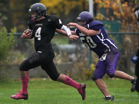 Riverside's Junior Labelle, left, escapes the tackle from Assumption's Matt Tran to score a touchdown in the first quarter of the WECSSAA football quarterfinal. (DAX MELMER/The Windsor Star)