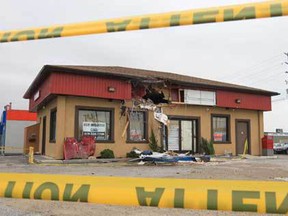 The damage to a building at 256 Talbot St. W. is shown Tuesday, Oct. 23, 2012, in Leamington, Ont. Two men are in hospital with life-threatening injuries after the truck they were travelling in launch into the air and struck the building at 1:42 a.m. Sunday.  (DAN JANISSE/The Windsor Star)