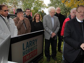 Larry Horwitz, right, along with Essex Mayor Ron McDermott, behind second from left, and other area candidates and supporters hold a press conference in East Riverside calling for a better regional public transportation system Tuesday October 21, 2014. (NICK BRANCACCIO/The Windsor Star)