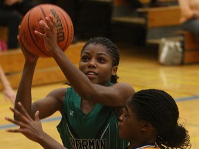 Herman's Jada Jackson, left, takes a shot over Sandwich's Shelby Thomas during high school basketball action at Sandwich Monday (TYLER BROWNBRIDGE/The Windsor Star)