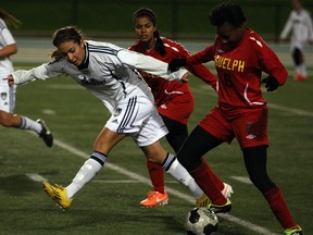 University of Windsor Lancers Jaclyn Faraci, left, battles with Guelph Gryphons Breanna Hall, right, and Sarah Magalhaes, behind, in OUA women's soccer at Alumni Field Wednesday October 22, 2014. (NICK BRANCACCIO/The Windsor Star)