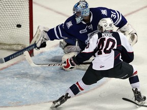 Windsor's Ryan Moore, right, scores a goal against Mississauga goaltender Spencer Martin at the WFCU Centre. (NICK BRANCACCIO/The Windsor Star)