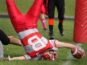 Brennan's Landon Porter gets upended just short of the goal line during Friday's 35-7 victory against L'Essor at Brennan. (DAN JANISSE/The Windsor Star)