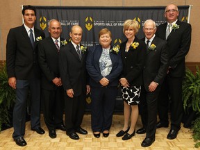 Windsor/Essex County Sports Hall of Fame inductees Bobby Kokavec, from left, Dave Prpich, Nino Marion, Sandy Repko, Lori-Scott Pinter, Bill Hogarth and Stan Korosec pose for a group photo at the Caboto Club Friday. Darren McCarty didn't attend the event. (TYLER BROWNBRIDGE/The Windsor Star)