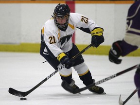 Windsor's Bree Polci, left, carries the puck in front of Western's Katelyn Gosling at South Windsor Arena. (DAX MELMER/The Windsor Star)