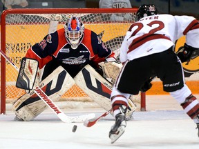 Windsor goaltender Alex Fotinos, left, stops Guelph's Pius Suter during OHL action in Guelph Friday. (Tony Saxon/Guelph Mercury)