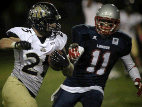 AKO's Brandon Donkers carries the ball against the London Beefeaters in an OFC semifinal game at Windsor Stadium. (DAX MELMER/The Windsor Star)