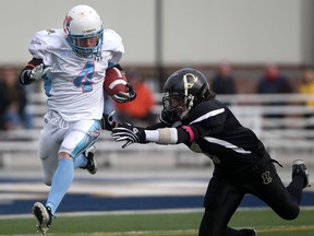 Hamilton's Stephen Jordan, left, is tackled by Windsor's Jake Nicoletti at Alumni Field in 2011.  (DAX MELMER/The Windsor Star)