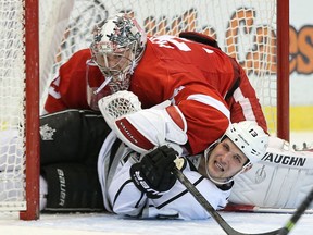 Detroit goalie Jimmy Howard, top, gets tangled up with Kyle Clifford of the Kings at Joe Louis Arena. Photo by Leon Halip/Getty Images)