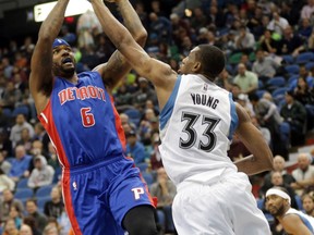 Minnesota's Thaddeus Young, right, guards Detroit's Kentavious Caldwell-Pope Thursday in Minneapolis. (AP Photo/Jim Mone)