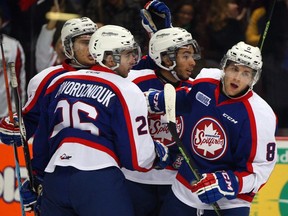 Windsor's Trevor Murphy, right, is congratulated by teammates Sam Povorozniouk, from left, Cristiano Digiacinto and Josh Ho-Sang against the Kingston Frontenacs at the WFCU Centre. (NICK BRANCACCIO/The Windsor Star)