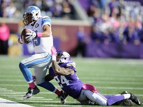 Minnesota's Captain Munnerlyn, right, pushes Detroit's Golden Tate out of bounds during the third quarter on October 12, 2014 at TCF Bank Stadium in Minneapolis, Minnesota. The Lions defeated the Vikings 17-3. (Hannah Foslien/Getty Images)