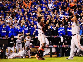 Buster Posey #28 , Madison Bumgarner #40, Pablo Sandoval #48 and the San Francisco Giants celebrate after defeating the Kansas City Royals to win Game Seven of the 2014 World Series by a score of 3-2 at Kauffman Stadium on October 29, 2014 in Kansas City, Missouri.  (Photo by Jamie Squire/Getty Images)