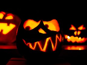 Three pumpkins carved as grimacing faces and having candles inside glow in the dark on Oct. 28, 2014 in Hanover, central Germany, days before Halloween.       AFP PHOTO / DPA / OLE SPATA / GERMANY OUTOle Spata/AFP/Getty Images