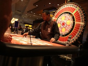 A dealer hands out chips at a table at the MGM Grand Detroit casino November 19, 2008 in Detroit. (Getty Images files)