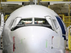 A commercial jetliner receives maintenance work at Premier Aviation, Friday, Oct. 17, 2014.  (DAX MELMER/The Windsor Star)