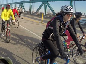 Brittany Fillmore, right, from Detroit, joins approximately 500 other cyclists as they cross the Ambassador Bridge and back for Tour de Troit's annual 'Bike the Bridge' event, Sunday, Oct. 12, 2014.  The tour continued on throughout Windsor.  (DAX MELMER/The Windsor Star)