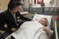 Susanna Chan, a concierge at Windsor Regional Hospital - Met Campus, prepares a warm blanket Lorraine Brisson, 91,   in the emergency room, Saturday, Oct. 18, 2014.  (DAX MELMER/The Windsor Star)