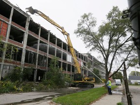 Crews start demolishing part of the Packard Plant in Detroit, Friday, Oct. 17, 2014, more than 50 years after the last car was produced there. A developer from Peru bid $405,000 for the property during a tax foreclosure auction last year. (AP Photo/Carlos Osorio)