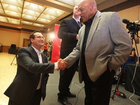 Windsor councillor Irek Kusmierczyk (L) shakes hands with outgoing councillor Ron Jones on Monday, Oct. 27, 2014, at the Caboto Club in Windsor, ON. (JASON KRYK/The Windsor Star)