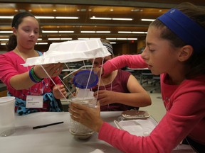 rom left, Brenna Johnston, 12, Samantha Blackwell, 12, and Olivia Lutfallah, 12, work together to construct a device that will protect an egg from a second story drop while at the Go Engineering Girl at the Ed Lumley Centre for Engineering, Saturday, Oct. 25, 2014.  Girls from grade seven through ten were given a chance to explore the wide range of opportunities and careers available in engineering.   (DAX MELMER/The Windsor Star)
