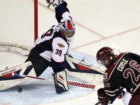 The Windsor Spitfires Alex Fotinos makes a save on the Peterborough Petes Josh Coyle at the WFCU Centre in Windsor on Thursday, October 9, 2014.                      (TYLER BROWNBRIDGE/The Windsor Star)