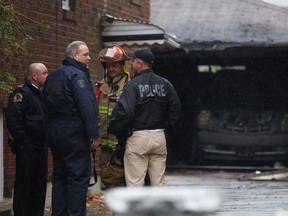Windsor Police Arson Unit investigates two suspicious garage fires at 882 Louis and 695 Parent on October 31, 2014 (DAX MELMER/Windsor Star)
