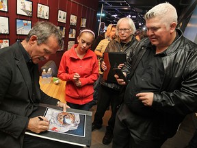 Canadian astronaut, Chris Hadfield, signs autographs after appearing at the Windsor Star News Cafe, Friday, Oct. 17, 2014. (DAX MELMER/The Windsor Star)