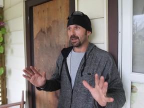 J.P. Bonyai stands next to a boarded up window at his home following an encounter with a home invasion suspect.  (JASON KRYK/The Windsor Star)