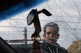 Sunil Nar looks through the cracked windshield of his van in Windsor on Monday, October 20, 2014. Nar's hood flew open while he was driving along the I75 in Detroit. Customs officers opened his hood at the border and Nar believes they failed to secure it properly.               (TYLER BROWNBRIDGE/The Windsor Star)