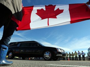 Cpl. Nathan Cirillo's body is transported by hearse from Ottawa to Hamilton via the Highway of Heroes, October 24, 2014. (Jean Levac/ Ottawa Citizen)