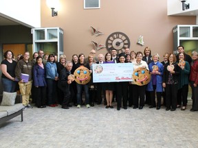 Staff at Maryvale Windsor accept a cheque from Tim Hortons. The $61, 638 was raised through the restaurants annual Smile Cookie campaign. (HANDOUT/The Windsor Star)