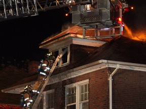 Windsor firefighters work to extinguish flames at a vacant home at 446 Indian Rd. on Oct. 28, 2014. (Nick Brancaccio / The Windsor Star)