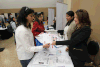 Sadia Basit and Sheeba Basit, left, talk with Women’s Enterprise Skills Training of Windsor Inc. (WEST Inc) employment specialists, Britney Lucier and Gurpreet Chana during the Windsor-Essex Annual Job Day held at the WFCU Centre in Windsor, Ontario on October 16, 2014. (JASON KRYK/The Windsor Star)