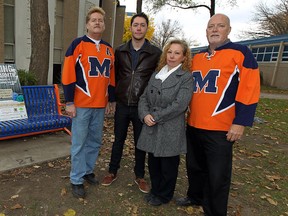 Matt Rawlings' family Paul Rawlings, Ryan Rawlings, Joy Rawlings and Bryan LaMarsh (left to right) are photographed at a bench that was dedicated to him at Massey high school in Windsor on Wednesday, October 29, 2014. Matt Rawlings died shortly after graduating from the school and now is family has launched a campaign to collect sleeping bags for the homeless in his name. Helping a homeless person was one of the items on the bucket list his family found after his death. (TYLER BROWNBRIDGE/The Windsor Star)