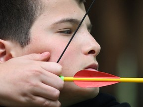 Cameron Christie tries archery at the Muskoka Woods camp in Rosseau, ON. Groups of local students have been visiting the camp for the past 20 years. (DAN JANISSE/The Windsor Star)