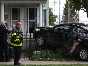 Emergency personnel tend to a two-car motor vehicle accident at the intersection of Elliott St. West and Janette Ave., Saturday, Oct. 18, 2014.  (DAX MELMER/The Windsor Star)
