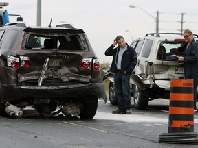 Police and tow truck crews work to clear a four vehicle accident from EC Row at Matchette Road in Windsor on Monday, October 14, 2014. The incident closed the west bound lanes for a couple hours and sent two people including a child to hospital with non life threatening injuries.                  (TYLER BROWNBRIDGE/The Windsor Star)