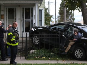 Emergency personnel tend to a two-car motor vehicle accident at the intersection of Elliott St. West and Janette Ave., Saturday, Oct. 18, 2014.  (DAX MELMER/The Windsor Star)