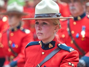 An RCMP officer marches in the procession to the regimental funeral for three slain RCMP officers in Moncton, N.B., Tuesday, June 10, 2014.  (Canadian Press files)