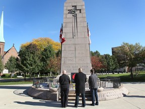 men pay tribute to Cpl. Nathan Cirillo at the downtown Windsor, ON. cenotaph on Thursday, Oct. 23, 2014. (DAN JANISSE/The Windsor Star)