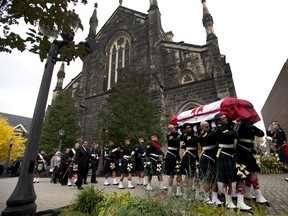 Pallbearers carry the coffin of Cpl. Nathan Cirillo during his regimental funeral service in Hamilton, Ont., on Tuesday, October 28, 2014. (THE CANADIAN PRESS/Nathan Denette)