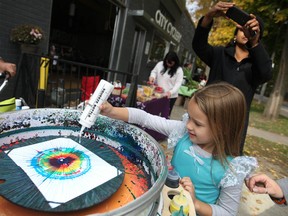 Sydney Love, 5, makes some art with a Spin Smoothie at the Windsor Underground Pop Up Market outside the City Cyclery, Saturday, Oct. 25, 2014.  The market has no official organizer and its location is announced only three days in advance.   (DAX MELMER/The Windsor Star)
