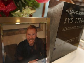 WINDSOR, ONT.:OCTOBER 10, 2014 -- A photo of Syd Strom sits next to a memorial stone at a memorial service and tree planting for Strom at Prince Edward Public School, Friday, Oct. 10, 2014.  Strom, a former teacher at Prince Edward Public School, died in July 2014 from Pancreatic Cancer.  (DAX MELMER/The Windsor Star)