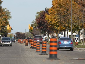 Orange construction cones line Sandwich St. in Amherstburg during road resurfacing work, Sunday, Oct. 19, 2014.  (DAX MELMER/The Windsor Star)